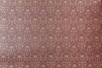 Patterned red wallpaper in the expensive interior. A lush red sofa pattern of swirls. Can be used as a background.