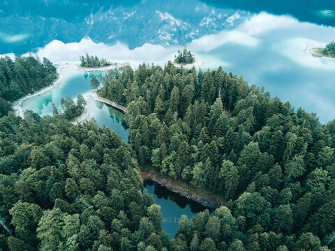 Aerial Drone photo of lake Eibsee with forest in Germany