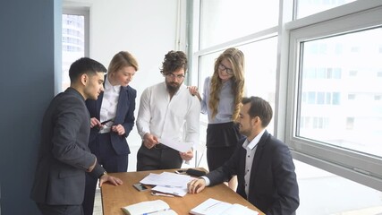 working atmosphere in the office. employees to view documents in the workplace. group of business people discussing business issues