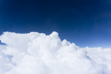 Deep blue sky above white fluffy cloud formation