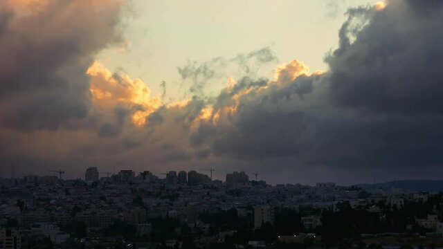 Sunset with huge cumuli clouds over the city timelapse. Jerusalem sunset at night dusk.