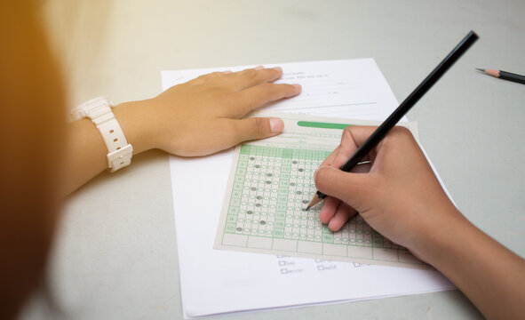 blurred of Asian, Thai student testing in exercise, or taking exams answer sheets in school class room