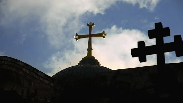 Golden cross over Temple of the Holy Sepulcher church in Jerusalem timelapse. The Holy Sepulchre Church is the most sacred place for all Christians in the world.