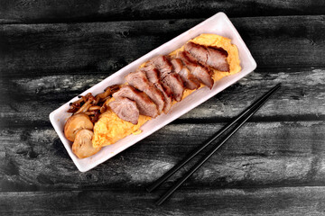 Omelet topped pork steak and grilled mixed mushroom.