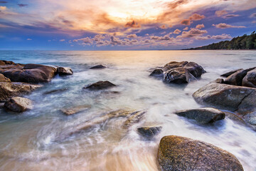 Sunset on the beach at Mae Rumphueng beach , Rayong , Thailand. Long exposure of the wave during sunset on the beach..
