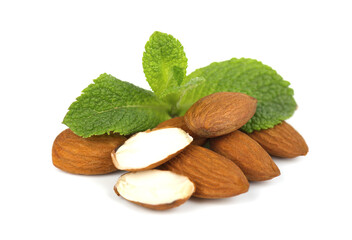 Pile of peeled almonds, with a sprig of mint, isolated on a white background.