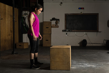 Woman ready to jump on a box