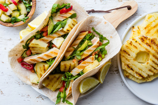 Mexican barbecue chicken and pineapple tacos with vegetables served with pineapple chili salsa