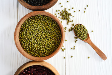 green bean in wooden bowl isolated on white background