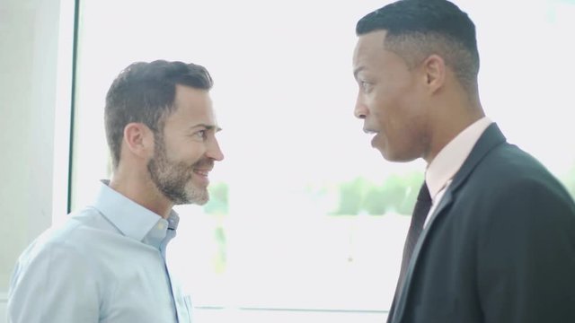Business colleagues chatting face to face