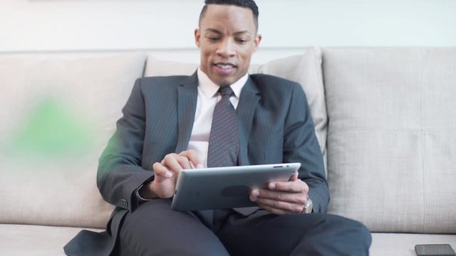 Mid adult man using digital tablet