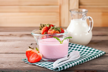 Strawberry yogurt and milk on a table. Selective focus. Copy space