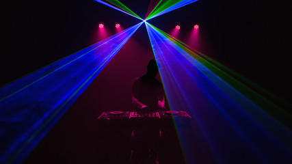 Disc jockey, DJ, Silhouette on laser beams