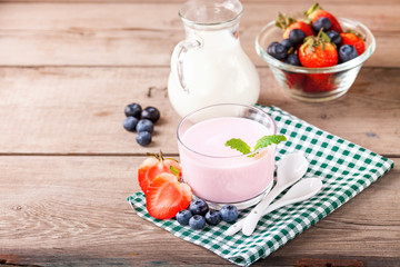 Strawberry yogurt and milk on a table. Selective focus. Copy space