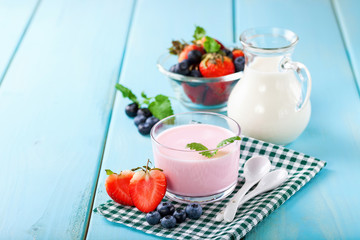 Strawberry yogurt and milk on a table. Selective focus. Copy space