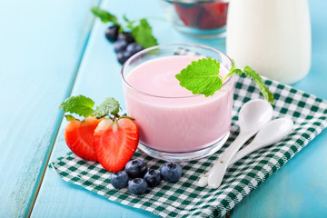 Strawberry yogurt and milk on a table. Selective focus. Copy space