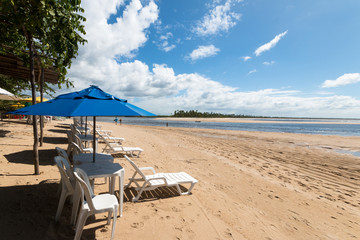 Umbrella and beach chairs on tropical island