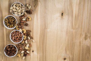 Nuts in a plates on a  wooden table
