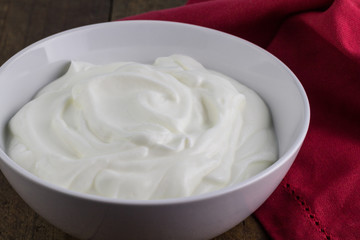 Fototapeta na wymiar Natural yoghurt in white ceramic bowl