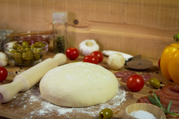 Ingredients for the preparation pizza on wooden background