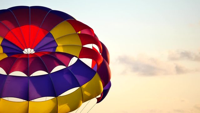 Parasailing provide services to tourists on sky in sunset time.