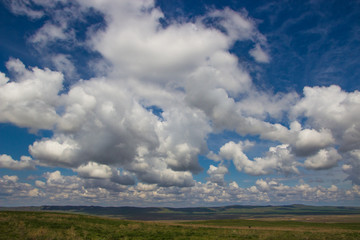 Fototapeta na wymiar Steppe in spring, Kazakhstan. Amazing clouds and sky