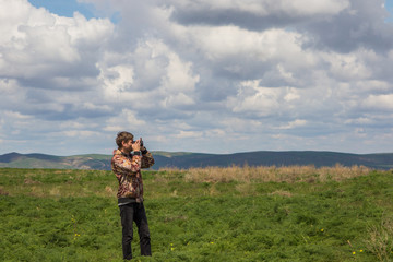 Photographer at the steppe in Kazakhstan. Amazing cloudy sky