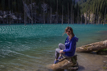 Young woman at Kaindy lake, Tien Shan mountain, Kazakhstan