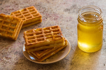 Baked waffles and organic sweet honey for breakfast