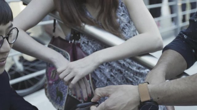 Man looking at friend's mobile phone