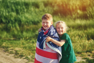 Fototapeta na wymiar a truly Patriotic children with USA flag . The concept of independence day