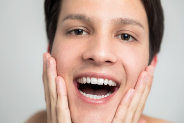 Obraz premium men's oral care concept. a man has regular teeth.