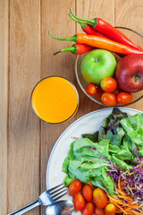 Healthy concept with mixed fruits and vegetables on wooden background