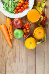 Healthy concept with mixed fruits and vegetables on wooden background