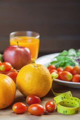 Healthy concept with mixed fruits and vegetables on wooden background