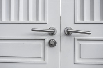 Stainless steel door knob on white door
