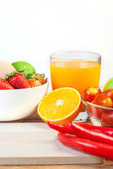 Healthy concept with mixed fruits and vegetables on wooden background