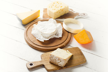 Cheese on a white wooden board.