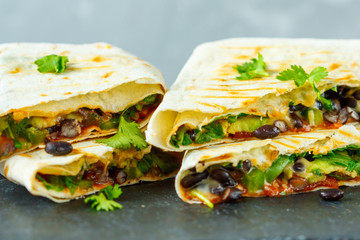 Vegetarian burritos wraps with beans, avocado and cheese. Love for a healthy vegan food concept