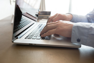 Caucasian man using laptop at table