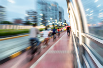 Slow exposure photo in Miraflores, Lima, Peru over a bridge with pedestrians and bikers in the evening