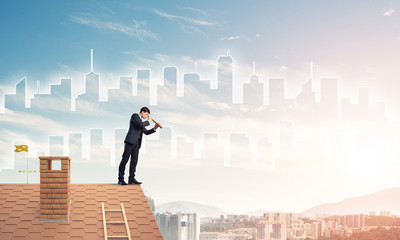 Engineer man standing on roof and looking in spyglass. Mixed med