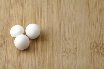 Moth balls over the wooden board