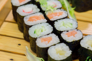 Sushi sea food in the restaurant close up. King prawns, seaweed and caviar for gourmets.