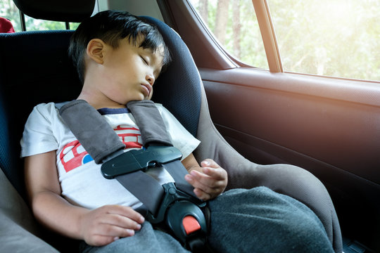 Asian Boy Sleeping In Child Car Seat.