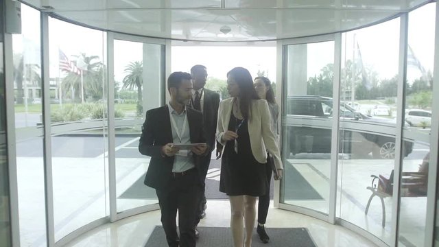 Executives entering hotel lobby
