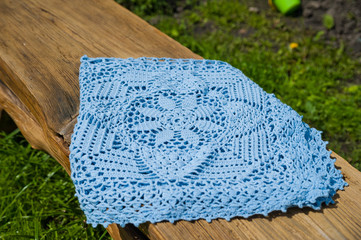 Blue knitted plaid by hand. Plaid and blue yarn with a beautiful pattern
