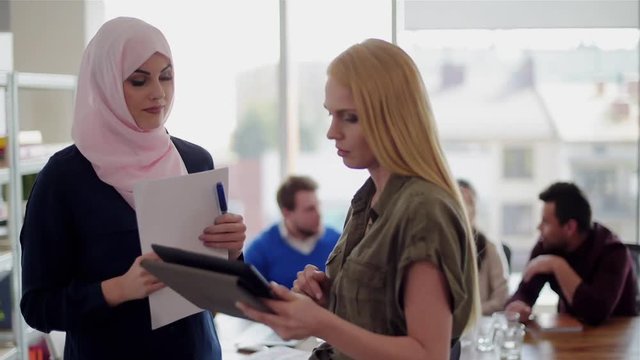 Two women talking at work