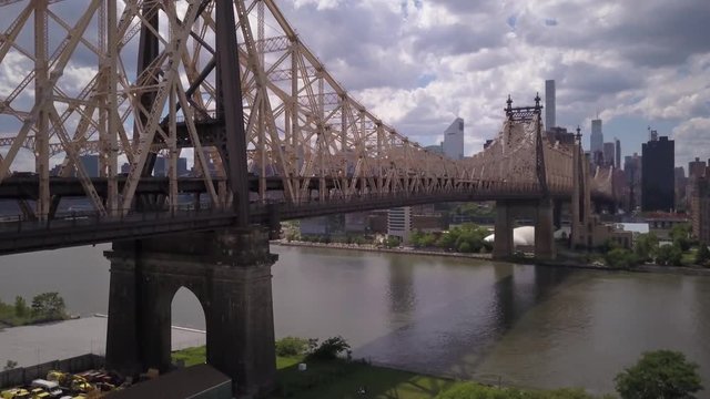 rising over Queensboro Bridge to reveal view of Manhattan