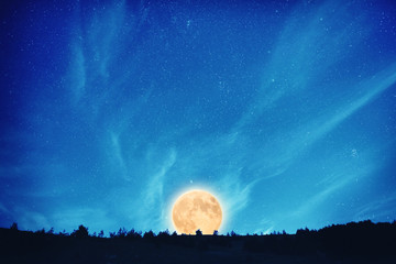 Fototapeta na wymiar Full moon at night on the dark blue sky